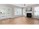 Light-filled living room with fireplace and doors to outdoor deck at 128 Low Country Ct, Morrisville, NC 27560