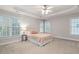 Main bedroom features tray ceiling, multiple windows and neutral decor at 128 Low Country Ct, Morrisville, NC 27560
