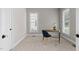 Bright office space featuring carpeted floors, desk, chair, and two large windows at 128 Low Country Ct, Morrisville, NC 27560