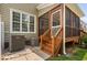 Exterior view of screened porch with stairs, AC units, and adjacent windows at 128 Low Country Ct, Morrisville, NC 27560