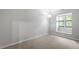 Empty bedroom with a single window and neutral carpet at 130 E Longview St # Apt S, Chapel Hill, NC 27516