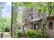 Charming exterior elevation featuring a wooden facade, covered entryways, and mature trees at 130 E Longview St # Apt S, Chapel Hill, NC 27516