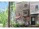 View of a rustic, multi-story townhouse with weathered wood siding and a small deck at 130 E Longview St # Apt S, Chapel Hill, NC 27516