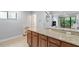 Stylish kitchen featuring granite countertops, wood cabinets, and a tile floor at 130 E Longview St # Apt S, Chapel Hill, NC 27516