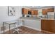 This is a great kitchenette with wood cabinets, granite countertops, and a desk area at 130 E Longview St # Apt S, Chapel Hill, NC 27516