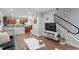 Open concept living space with hardwood floors, a mounted television, and a dining area at 130 E Longview St # Apt S, Chapel Hill, NC 27516