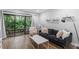 Inviting living room featuring sliding glass doors to the outside, neutral walls, and hardwood flooring at 130 E Longview St # Apt S, Chapel Hill, NC 27516