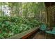 Lush patio area with bench and chairs surrounded by plants and greenery at 130 E Longview St # Apt S, Chapel Hill, NC 27516