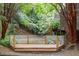 Wooden patio surrounded by green trees and bamboo at 130 E Longview St # Apt S, Chapel Hill, NC 27516