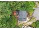Aerial view of a home featuring a gray roof, surrounding greenery, and a deck in a peaceful setting at 1312 Stonemoor Ct, Raleigh, NC 27606