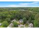 Breathtaking aerial view of the property nestled among lush trees and overlooking a scenic lake at 1312 Stonemoor Ct, Raleigh, NC 27606
