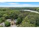 Stunning aerial view of the property surrounded by lush trees and overlooking a beautiful lake at 1312 Stonemoor Ct, Raleigh, NC 27606
