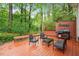 Relaxing backyard deck with a grill and seating, perfect for outdoor entertaining at 1312 Stonemoor Ct, Raleigh, NC 27606