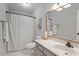 Clean bathroom featuring a vanity, toilet, and a shower with a white curtain for privacy at 1312 Stonemoor Ct, Raleigh, NC 27606