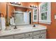 Bathroom featuring a double sink vanity, shower, and a window providing natural light at 1312 Stonemoor Ct, Raleigh, NC 27606