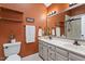 Bright bathroom with double vanity, white cabinets, and decorative shelves at 1312 Stonemoor Ct, Raleigh, NC 27606