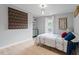 Bright bedroom featuring a patterned bedspread, natural light, and simple decor at 1312 Stonemoor Ct, Raleigh, NC 27606