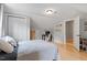 Comfortable bedroom with light hardwood floors, closet, desk and comfy bed with modern bedding and pillow at 1312 Stonemoor Ct, Raleigh, NC 27606