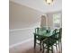 Cozy dining room featuring hardwood floors and a stylish green table set perfect for Gathering meals at 1312 Stonemoor Ct, Raleigh, NC 27606