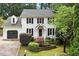 Charming two-story home with a brick facade, black shutters, and well-manicured landscaping at 1312 Stonemoor Ct, Raleigh, NC 27606