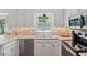 Lovely kitchen with stainless steel appliances, stone countertops, undermount lighting, and bright window at 1312 Stonemoor Ct, Raleigh, NC 27606