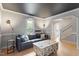 Stylish living room with a dark ceiling, hardwood floors, and a comfortable sofa near the staircase at 1312 Stonemoor Ct, Raleigh, NC 27606