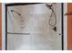 A frameless glass shower featuring a sleek shower head, corner shelves, and stylish hardware at 1312 Stonemoor Ct, Raleigh, NC 27606