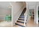 A staircase with hardwood steps and white risers leads to the upper level of the home at 1312 Stonemoor Ct, Raleigh, NC 27606