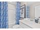 Stylish bathroom featuring a white vanity, toilet, a shower and a patterned blue shower curtain at 147 Sugar Pine Drive, Franklinton, NC 27525