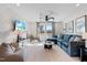 Cozy bonus room featuring a comfortable blue sectional, a ceiling fan, and a large window at 147 Sugar Pine Drive, Franklinton, NC 27525