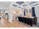 Bright dining room with a view of the kitchen, complemented by hardwood floors and a modern light fixture at 147 Sugar Pine Drive, Franklinton, NC 27525