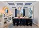 Elegant dining room featuring a coffered ceiling, stylish wallpaper, and modern furnishings at 147 Sugar Pine Drive, Franklinton, NC 27525
