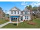 Stunning two-story home featuring a brick and stone facade, a well-manicured lawn, and a DRB Homes sales office at 147 Sugar Pine Drive, Franklinton, NC 27525
