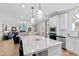 Modern kitchen flowing into the living area, featuring a quartz island and stainless steel appliances at 147 Sugar Pine Drive, Franklinton, NC 27525
