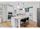 Modern kitchen featuring a center island with quartz countertops and stainless steel appliances at 147 Sugar Pine Drive, Franklinton, NC 27525