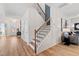 Modern staircase with wood and iron railings, creating a striking focal point in the entry hall at 147 Sugar Pine Drive, Franklinton, NC 27525
