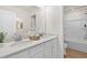 Elegant bathroom featuring double sinks, white cabinetry, and a separate shower/tub area for a spa-like experience at 148 Sugar Pine Drive, Franklinton, NC 27525