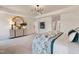 Spacious Primary bedroom with a decorative light fixture, large mirror, and plush carpeting, offering a tranquil retreat at 148 Sugar Pine Drive, Franklinton, NC 27525
