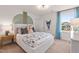 Cozy bedroom with a patterned bed, light blue curtains, and decorative wall art, creating a serene and stylish space at 148 Sugar Pine Drive, Franklinton, NC 27525