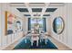 Elegant dining room with coffered ceilings, stylish lighting, and large windows at 148 Sugar Pine Drive, Franklinton, NC 27525