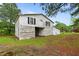 Exterior shot of an aged barn surrounded by greenery at 1517 Hodges Chapel Rd, Benson, NC 27504