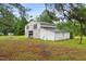 Exterior shot of an aged barn with pine straw and green grass surrounding it at 1517 Hodges Chapel Rd, Benson, NC 27504