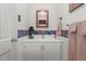Small bathroom with white walls, vintage cabinet, mirror, lighting and neutral accents at 1517 Hodges Chapel Rd, Benson, NC 27504