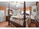 Spacious bedroom with four poster bed, dresser, and carpet at 1517 Hodges Chapel Rd, Benson, NC 27504