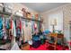 Spacious closet with floral wallpaper, shelving, hanging racks, and a dedicated sewing area at 1517 Hodges Chapel Rd, Benson, NC 27504