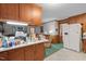 Spacious kitchen area with a white refrigerator and direct access to the living room at 1517 Hodges Chapel Rd, Benson, NC 27504