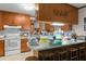 Kitchen with breakfast bar, great cabinet space, and tile flooring at 1517 Hodges Chapel Rd, Benson, NC 27504