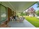 Spacious covered patio with outdoor seating and charming brick accents for outdoor gatherings at 1517 Hodges Chapel Rd, Benson, NC 27504