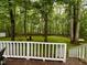 Enjoy a huge backyard with seating viewed from the back deck featuring white rails and stairs at 1634 Hurdle Mills Rd, Roxboro, NC 27574