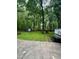 Large grassy backyard surrounded by mature trees at 1634 Hurdle Mills Rd, Roxboro, NC 27574